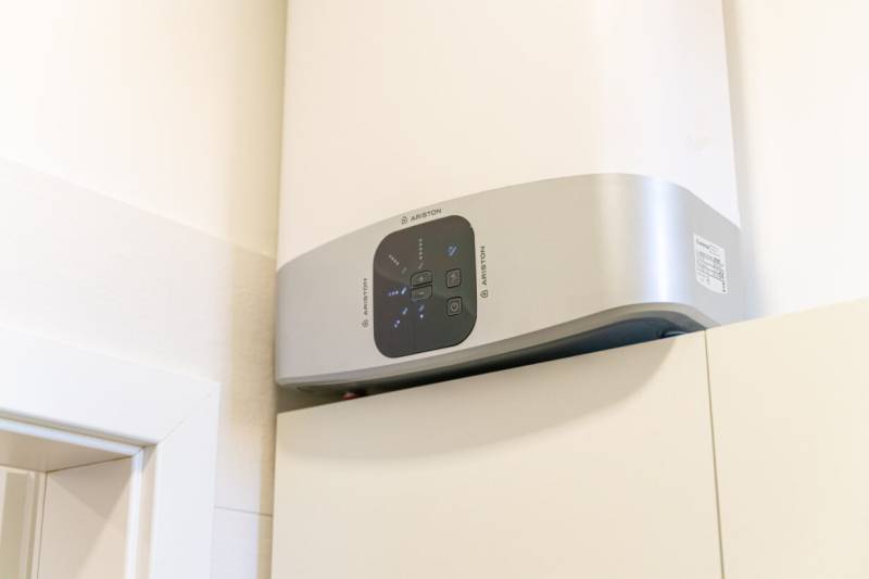 Electric water heater on the wall in a 2-room apartment, shown up close.