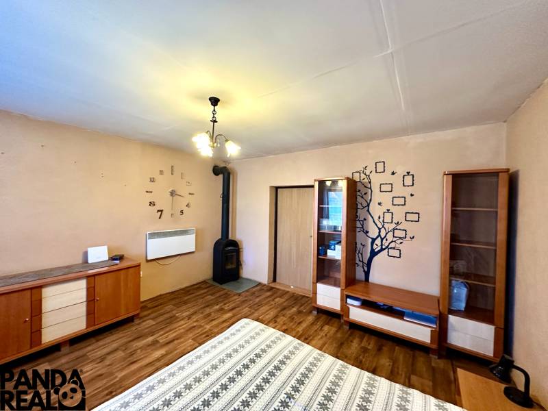 Family house with a fireplace, wooden furniture, and flooring with a wooden decor.