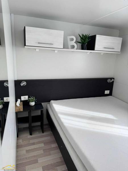 Minimalist bedroom with hanging cabinets and a wooden decor floor in unique properties.