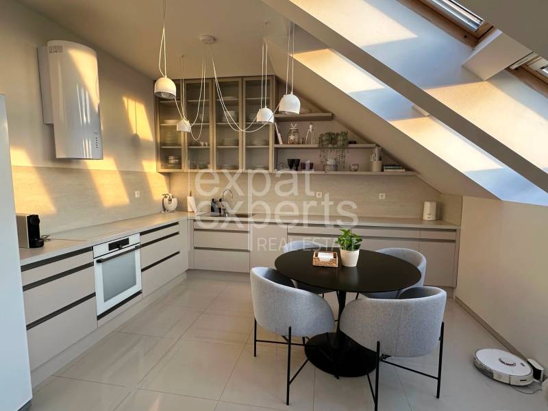 Bright kitchen with a dining table in a 3-room apartment, cozy attic.