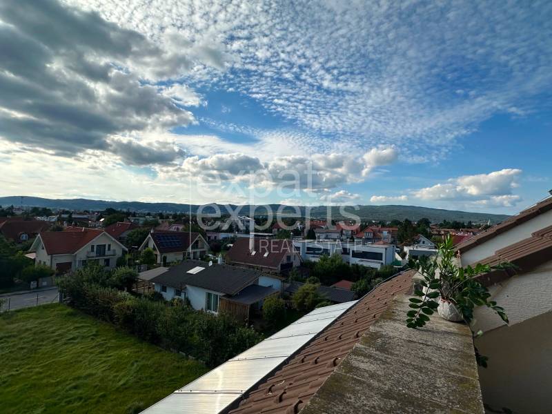 View of the residential area Bratislava - Vajnory with a vast sky and rooftops of houses.