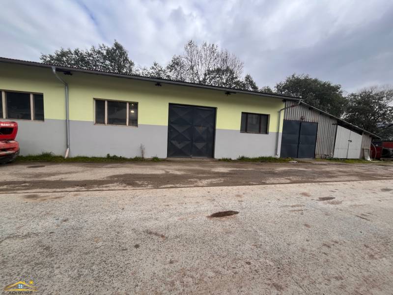 Warehouses and halls in Olešná, a building with a gate and windows, outdoor space.