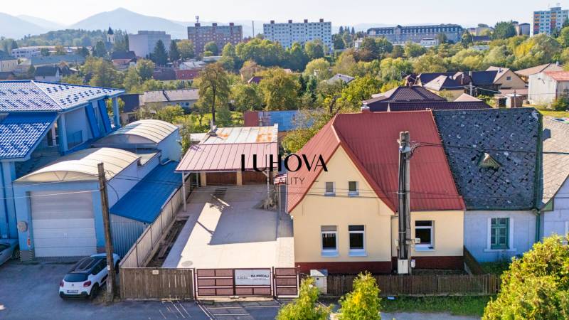 A family house on Sklárska Street in Lednické Rovne surrounded by greenery and buildings.