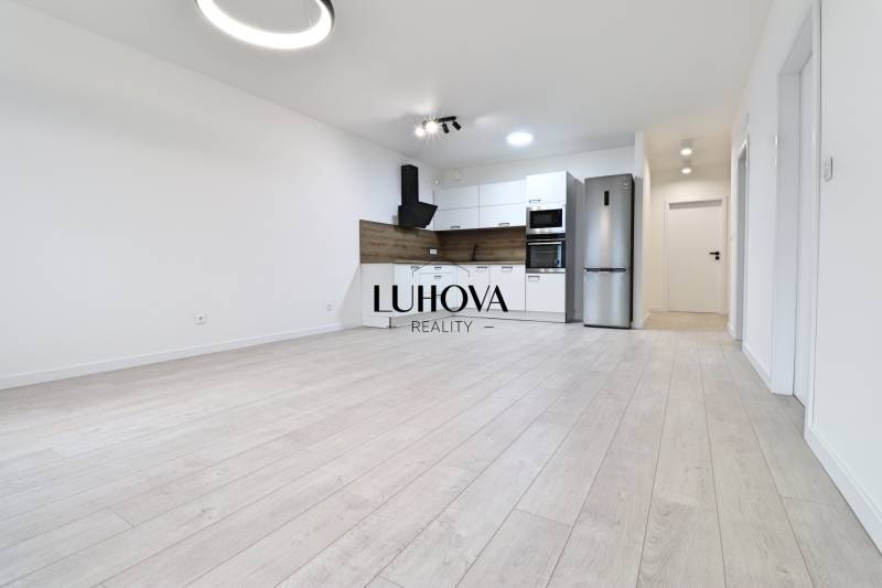 Kitchen in a 4-room apartment, bright space, white kitchen cabinets, floor with wood decor.