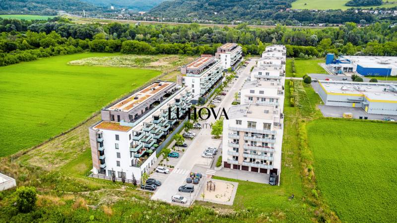 Púchov, exterior with apartment buildings and greenery, suitable for a 2-room apartment.
