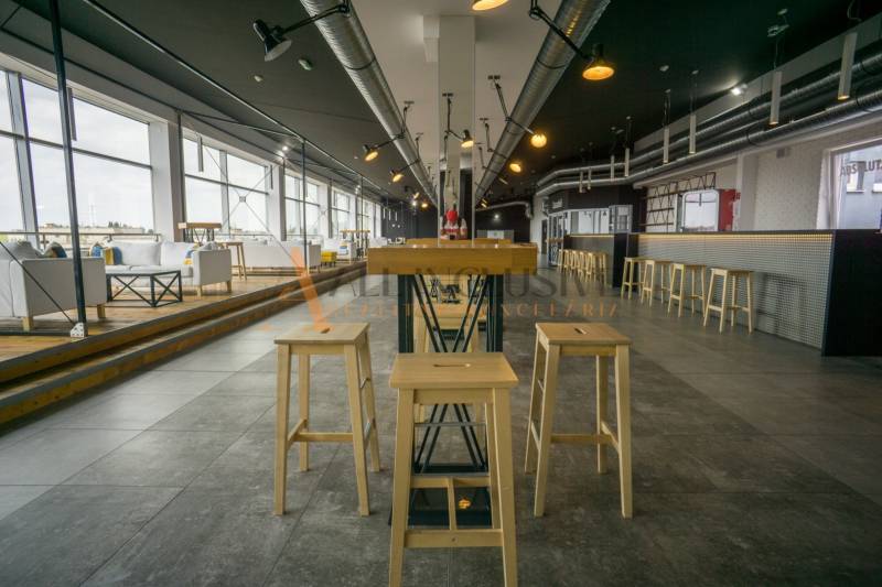 Spacious dining areas with wooden chairs and large windows.