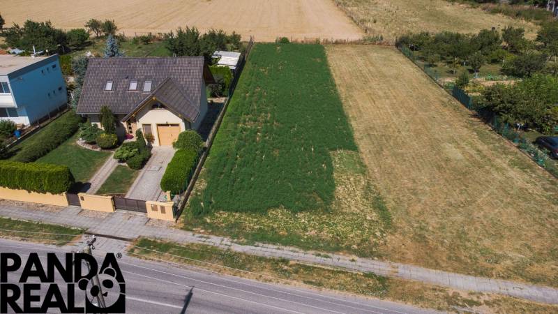 A family house with a large plot for living in Práznovce, surrounded by greenery and fields.