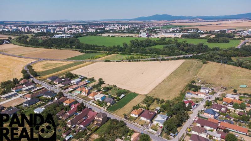 Aerial view of Práznovce, Land - residential areas near agricultural landscape.