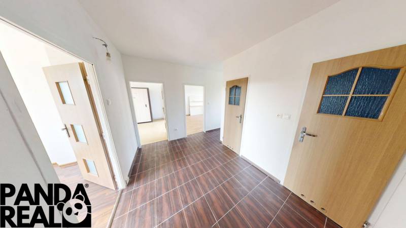 A hallway of a 4-room apartment with a wood-patterned floor and multiple doors.