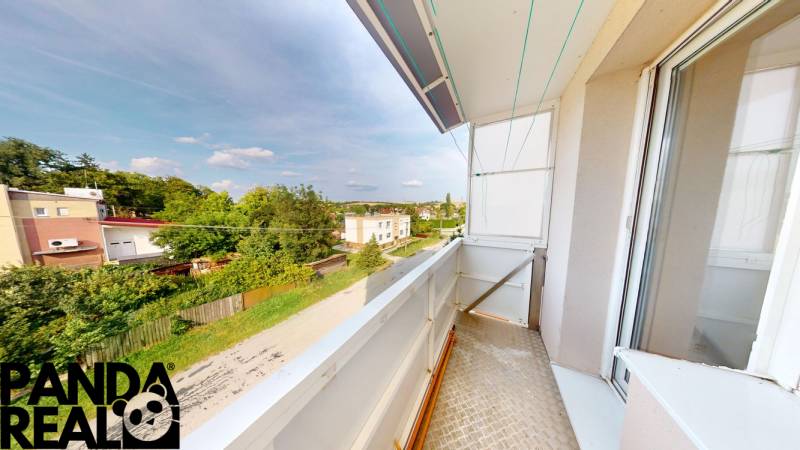 A balcony of a 4-room apartment in Horné Obdokovce with a view of the green surroundings.