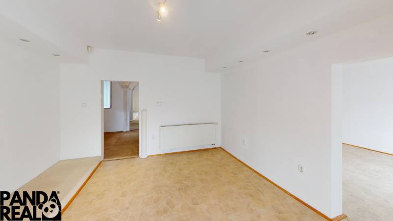 Interior of a family house with white walls and a floor with a wood decor.