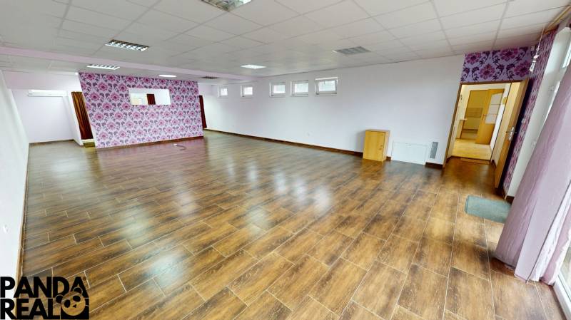Interior of a family house with a wooden decor floor and floral wallpaper.