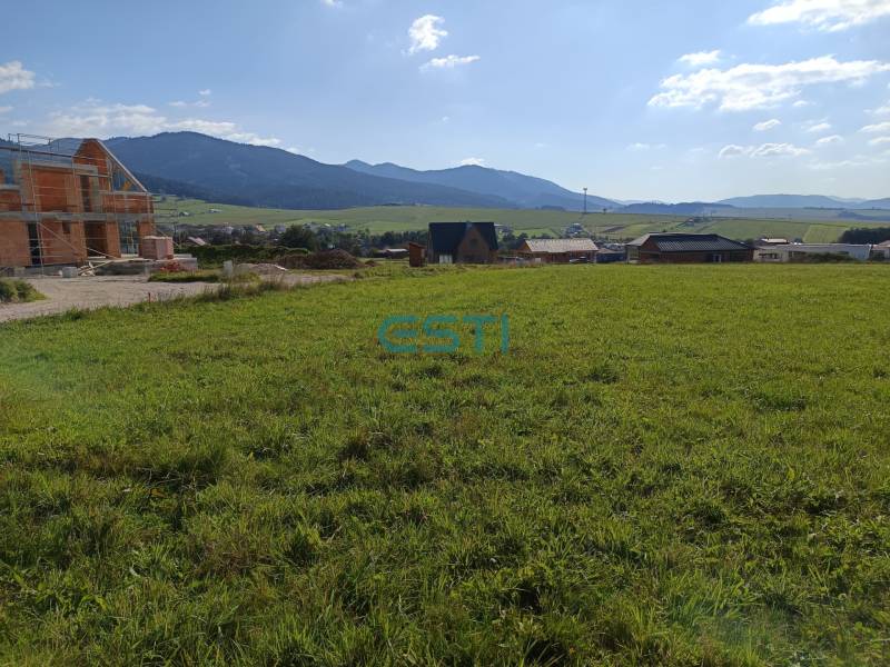 A plot for housing in Stránske with a view of the surrounding landscape and construction.