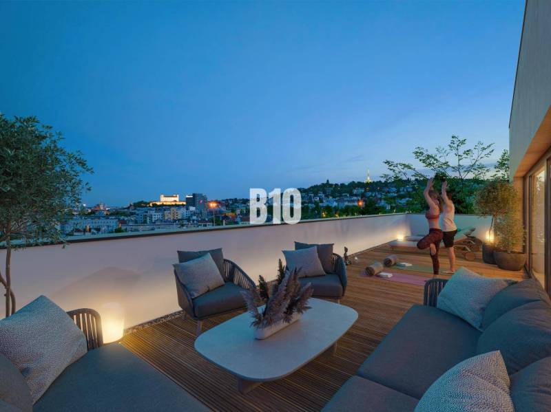 A terrace with a view of the city, comfortable seating, and people exercising in a 3-room apartment.