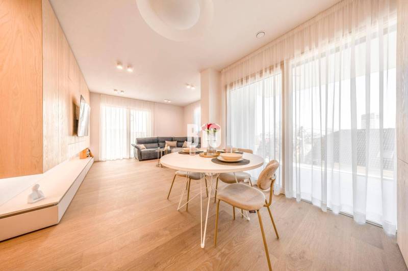 Living room in a 3-room apartment with a wood-patterned floor, dining table, and sofa.