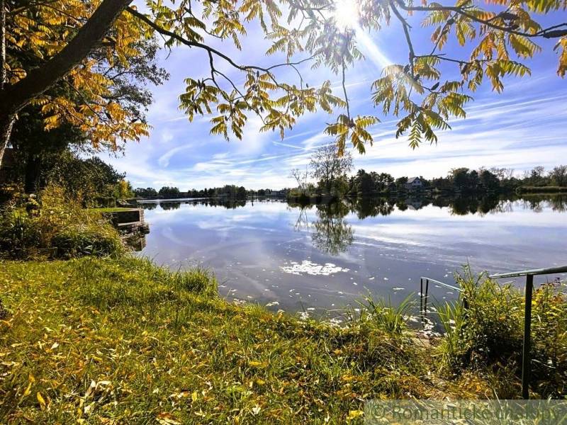 The lake near Malé Leváre with the gently setting sun and autumn nature.