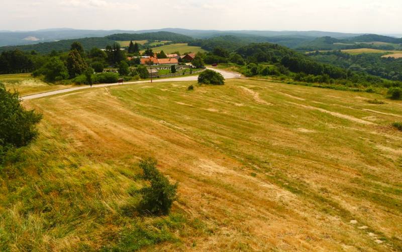 Agricultural and forest lands in Cerová with a visible village surrounded by green hills.