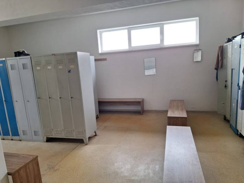 Locker room with lockers and benches in warehouses and halls, simple interior.