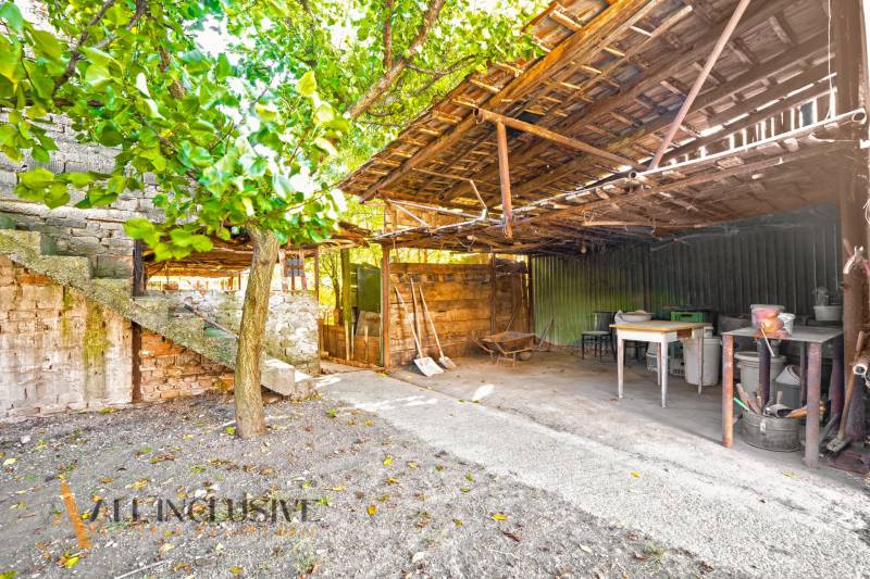 Outside a family house in the village of Veľká Mača, there is a gazebo with a wooden roof.