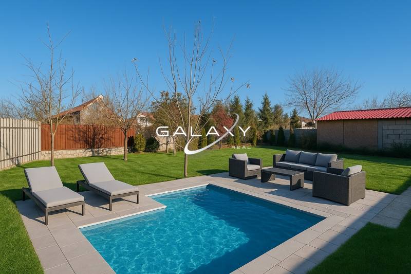 The courtyard of a family house in Horné Saliby with a garden pool and deck chairs.