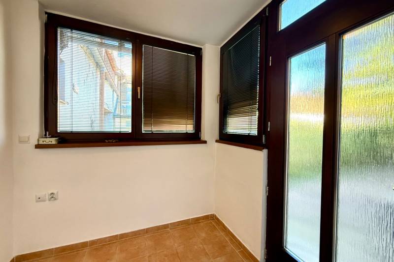 The interior of a family house with dark window frames and blinds on the windows.