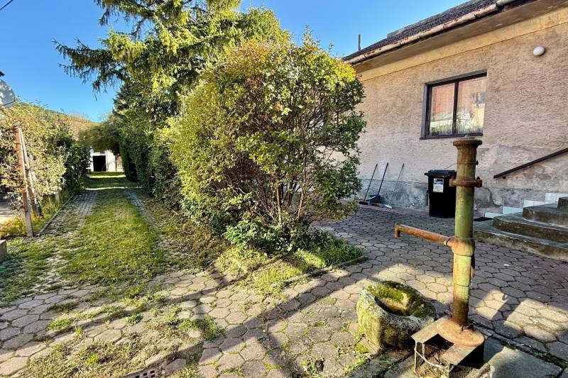 A family house on Prostredná Street in Svätý Jur with a courtyard and a well in the garden.