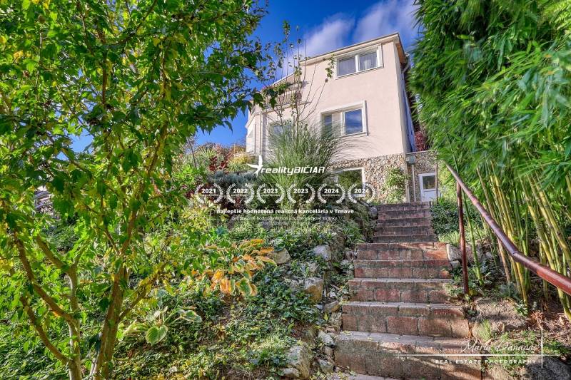 A family house in Bratislava - Devín with stone stairs, surrounded by a green garden.