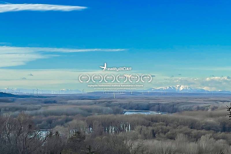 View of wind turbines and snowy peaks from a cottage in Bratislava - Devín.