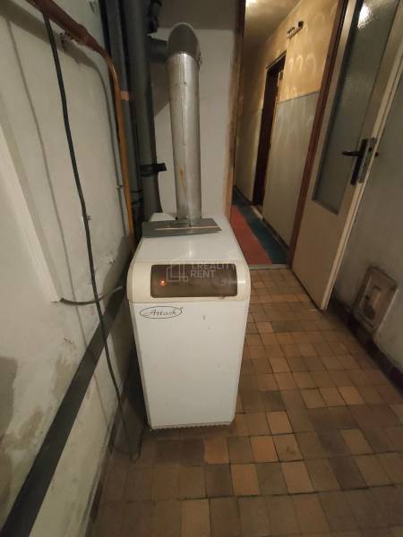 Heating in a boiler room in a family house with a floor with a wooden decor.