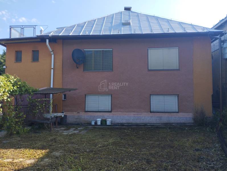 A family house in Divinka on Lalinek with a brown facade, satellite, and a shelter.