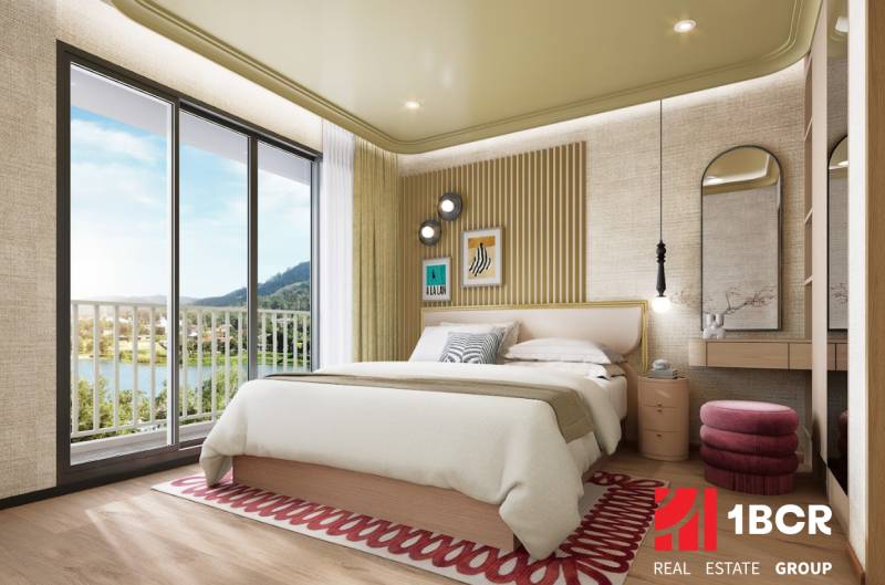 Bedroom in a two-room apartment with a bed, balcony doors, and a floor with a wooden decor.