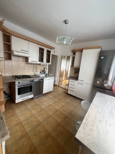 A kitchen in a 3-room apartment with a kitchen unit and built-in appliances.