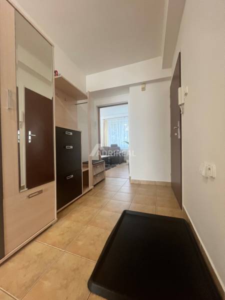 A hallway in a 3-room apartment with tiles and built-in furniture.