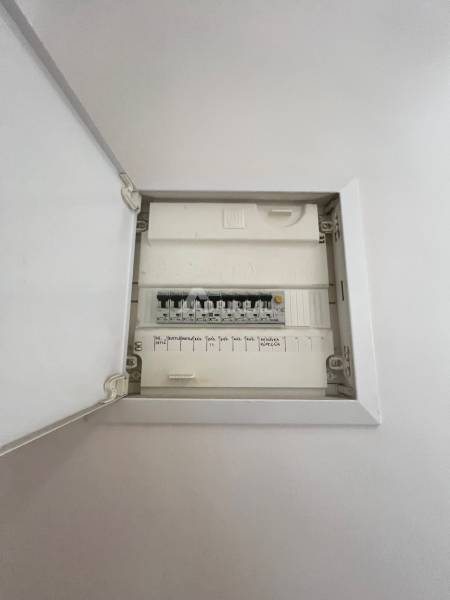 Electrical distribution box in a 3-room apartment with individual switches and descriptions.