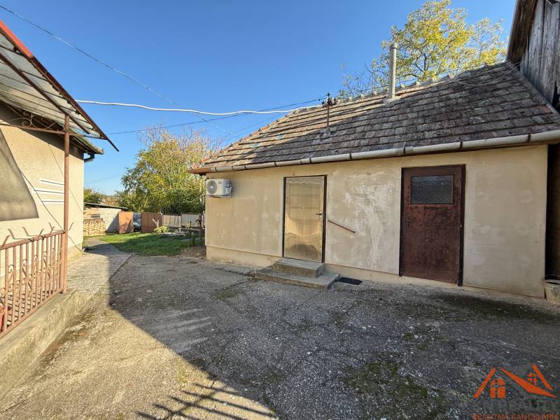 The courtyard of a family house on Malá Street in the town of Svätý Peter with older buildings and a garden.
