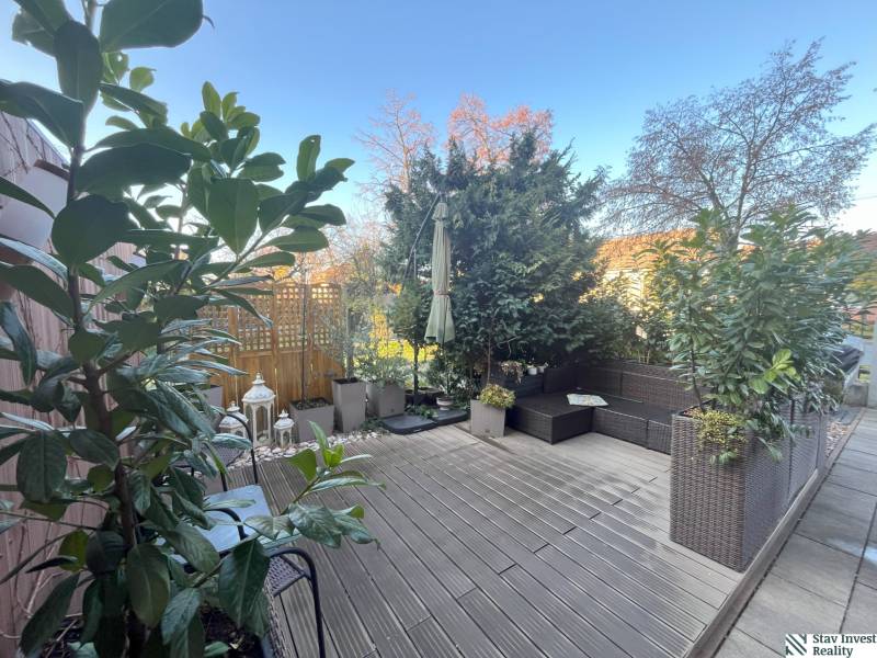 Terrace of a 2-room apartment in Bratislava - Ružinov with greenery and garden furniture.
