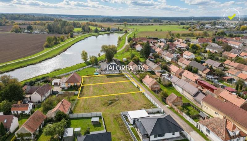Land - housing in Brodské by the river, surrounded by houses and nature.