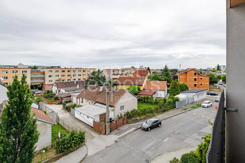 Pri strelnici Street in Ružinov, Bratislava with family houses and greenery.