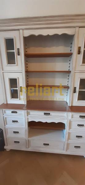 White display cabinet furniture with shelves and decorative handles in a 4-room apartment.