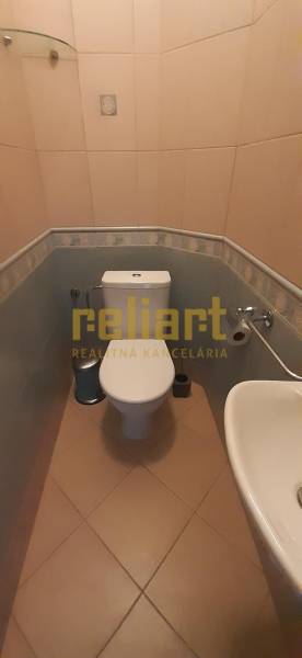 Bathroom with toilet in a 4-room apartment; light tiles, sink, and mirror.