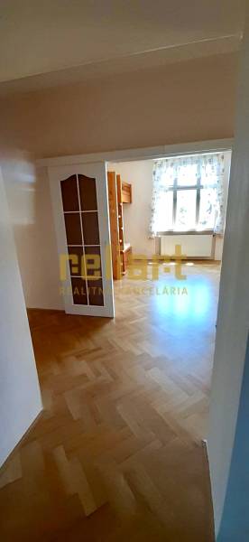 Interior of a 4-room apartment with a wooden decor floor and a wooden bunk bed.