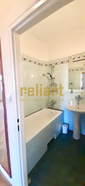 A bathroom with a shower and a sink in a 4-room apartment.