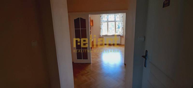 A room with a light window and a floor with a wooden decor, 4-room apartment.