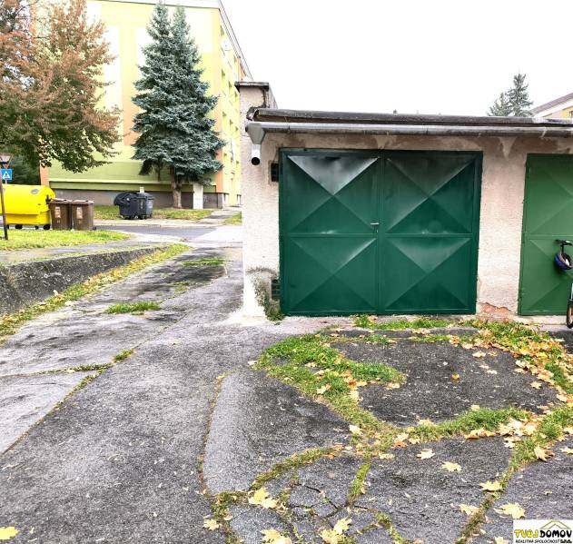 Garages on M. R. Štefánik Street in Detva with colorful containers and trees.