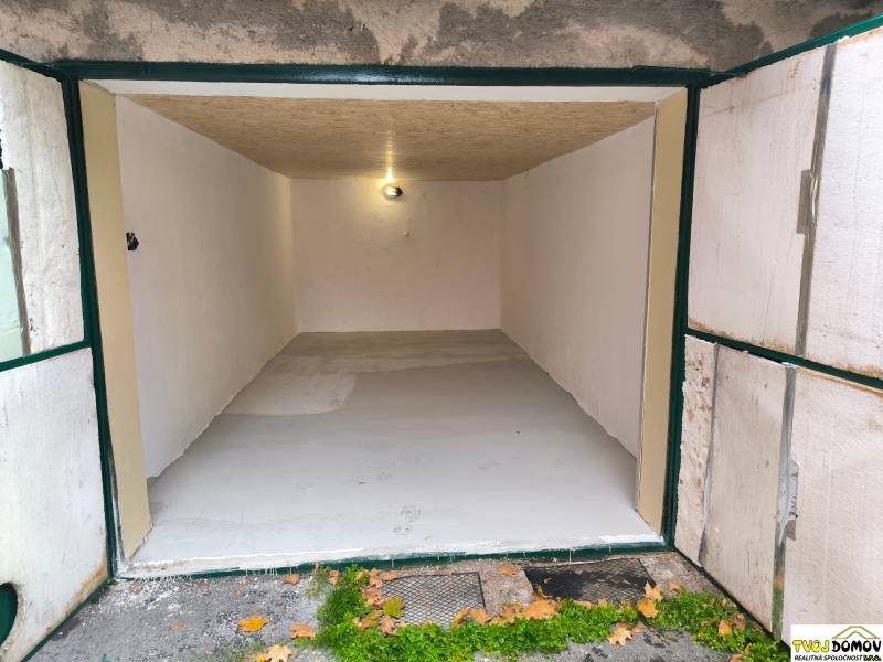 An open garage with white walls and simple lighting in Detva on M. R. Štefánika Street.