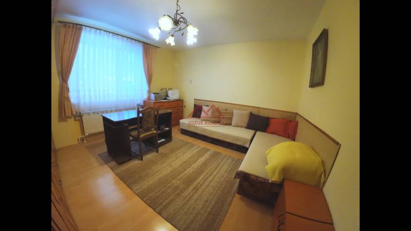 Living room with a sofa in a family house, floor with wooden decor.
