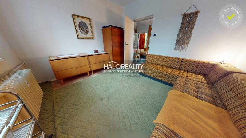 Living room with retro furniture in a 3-room apartment, light walls, comfortable sofa.