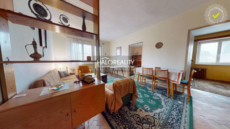 Living room in a three-room apartment with a wooden decor floor and furniture.