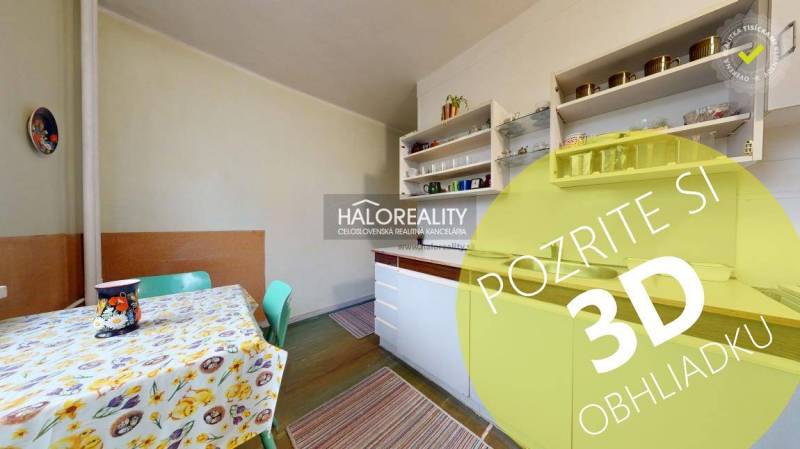 A kitchen in a 3-room apartment with a colorful table and shelves. Floor with wood decor.