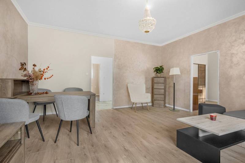 Bright living room with seating and wooden furniture in a 3-room apartment.